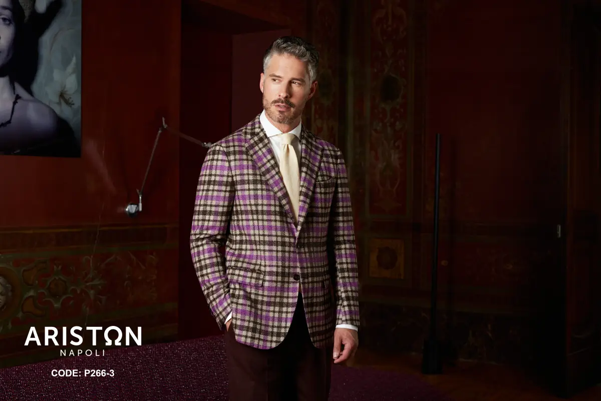 Brown check sport coat with purple overcheck, white shirt, pale gold silk tie, and chocolate trousers—heritage pattern with a modern pop